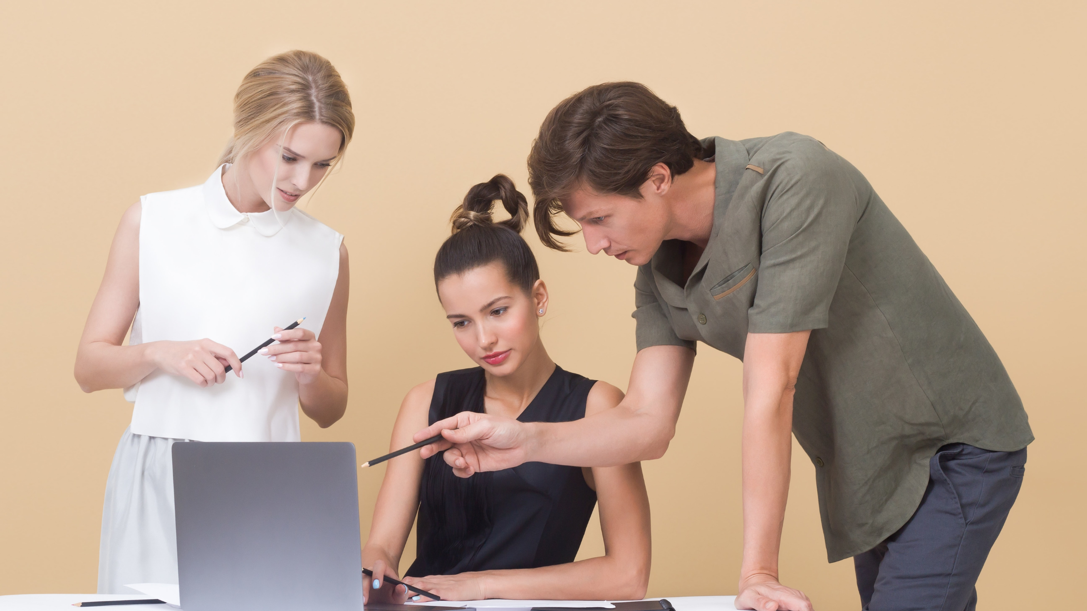 man-teaching-woman-while-pointing-on-gray-laptop